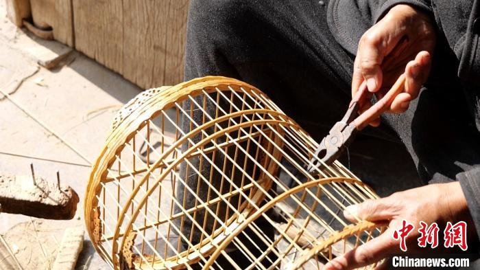 鳥(niǎo)籠藝人侯學(xué)文正在制作鳥(niǎo)籠。　巨野融媒中心供圖